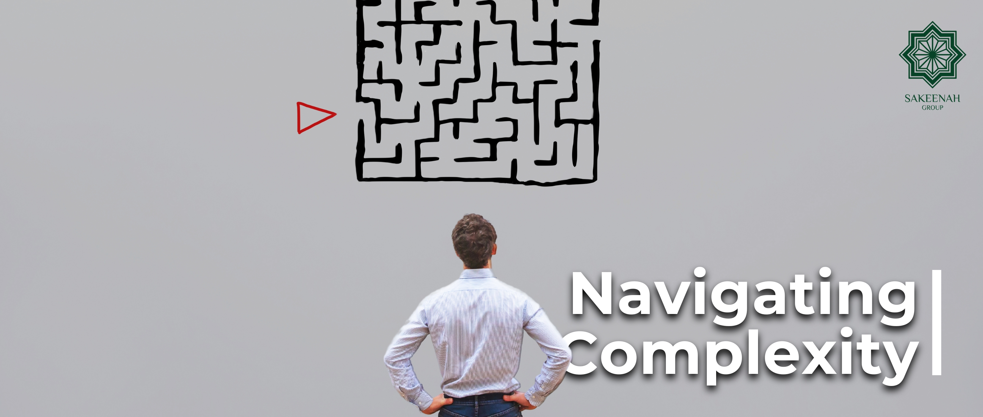 A man with his back turned, wearing a light blue striped button-down shirt and jeans, stands with his hands on his hips as he looks up at a simple, hand-drawn black maze on a grey wall. A small red arrow points to the entrance on the left side of the maze. The white text 'Navigating Complexity' is superimposed on the bottom-right corner, and the top-right corner features the green logo for 'SAKEENAH GROUP.