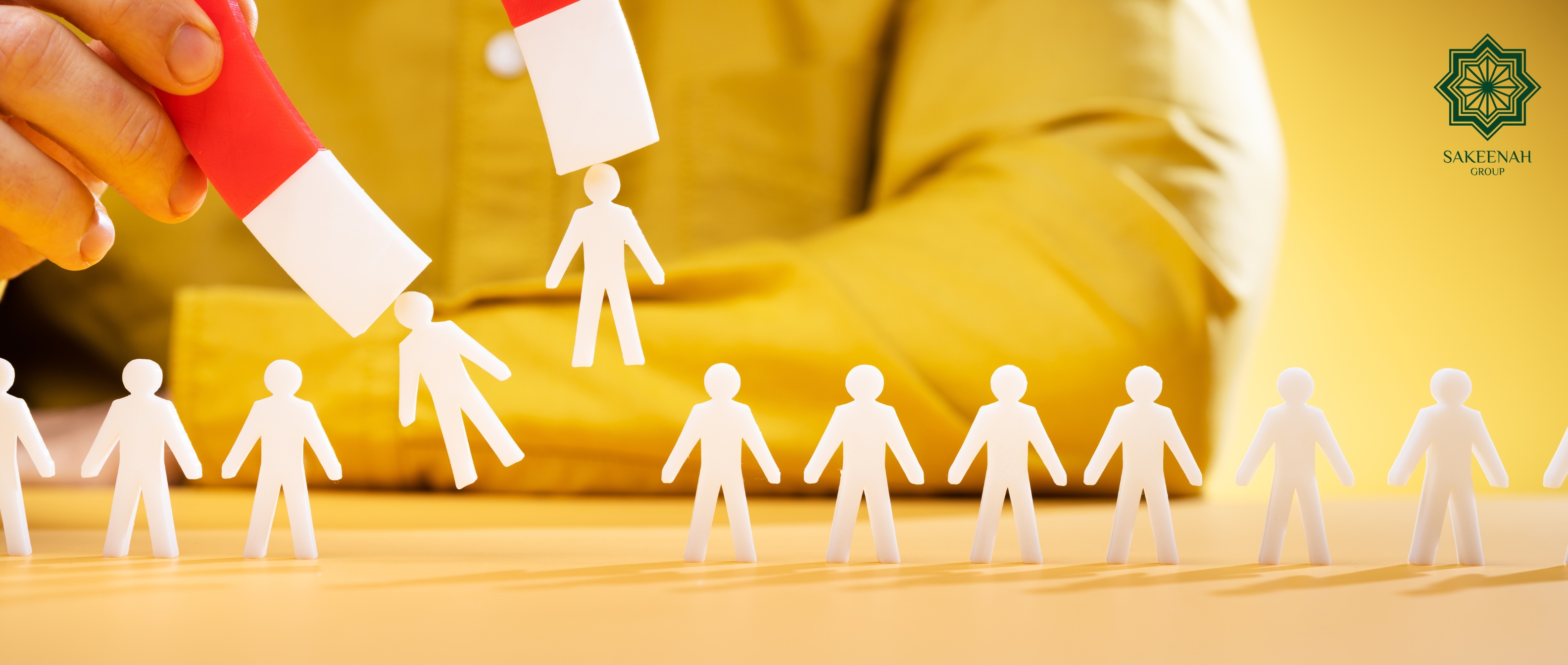 A magnet lifting specific lead profiles from a row of prospects, illustrating the process of lead qualification and follow-up with the Sakeenah Group logo.s