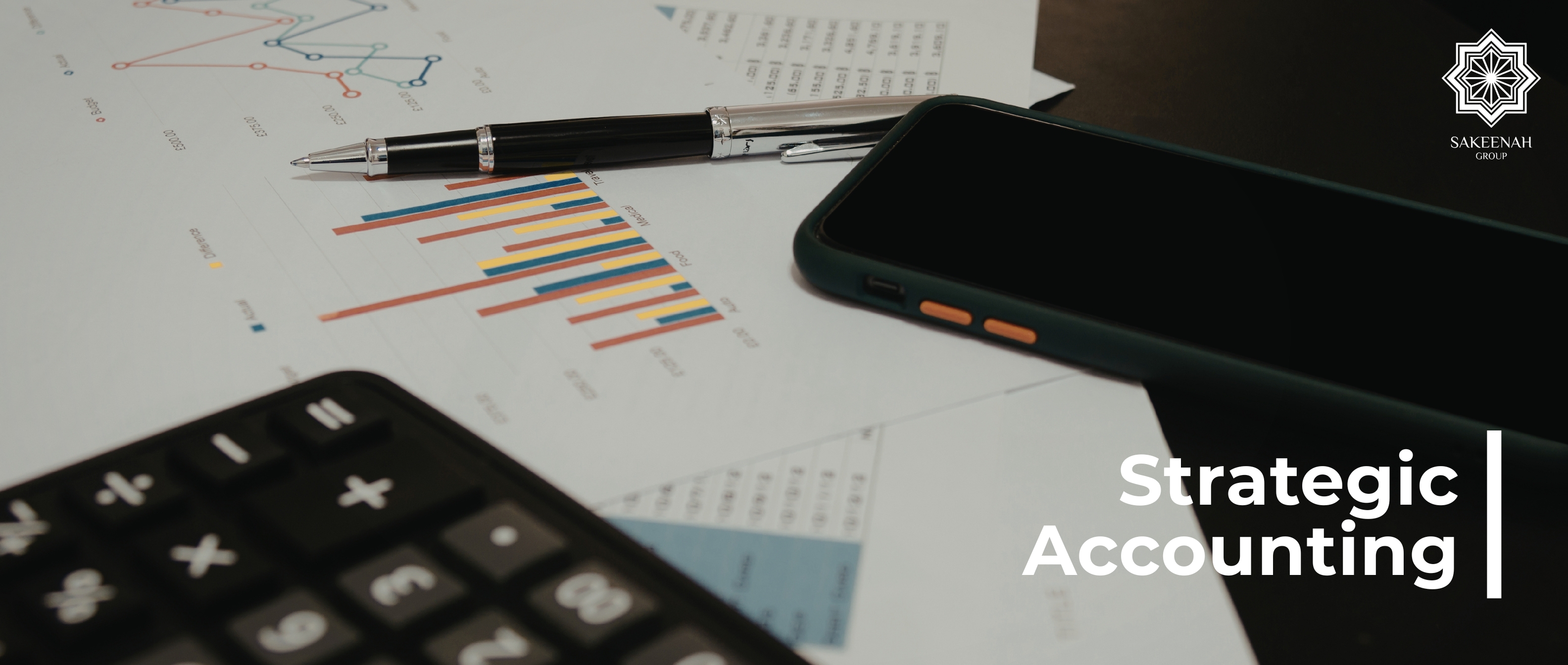 A high-angle, professional desktop scene featuring a calculator, a pen, a smartphone, and several financial charts with the text 