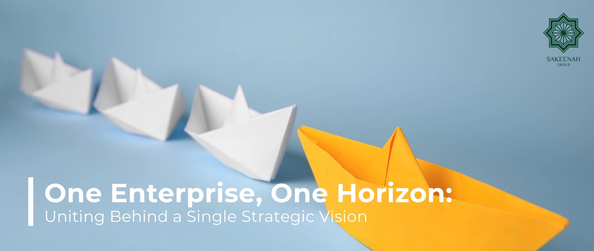 A bright yellow origami paper boat leading a row of white paper boats on a light blue background, symbolizing leadership alignment and strategic direction. The image features the Sakeenah Group logo in the top-right corner and a text overlay reading: 'One Enterprise, One Horizon: Uniting Behind a Single Strategic Vision.'
